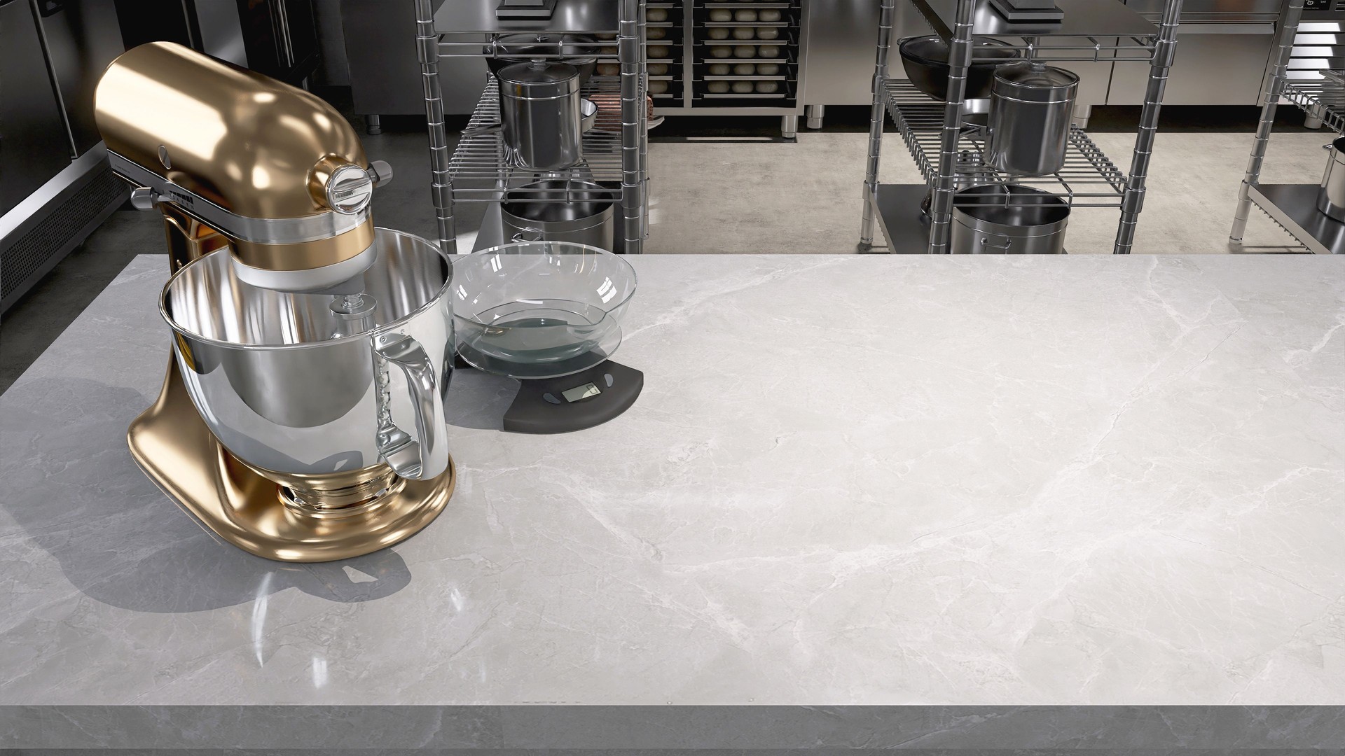 New gold professional kneading machine on white marble counter table in commercial bakery kitchen with stainless steel oven, refrigerator, shelf, cabinet